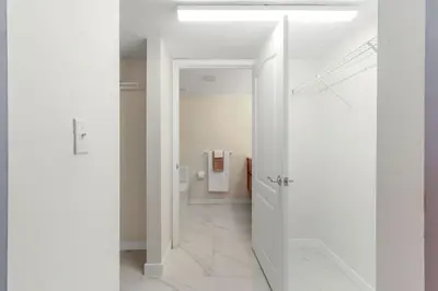 a hallway with white walls and a white door at Brickell Bay View Oasis with Pool Hot Tub and Gym in Miami