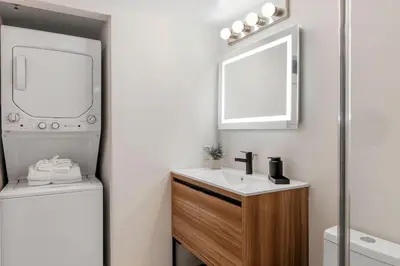 a bathroom with a sink and a mirror and a toilet at Brickell Bay View Oasis with Pool Hot Tub and Gym in Miami