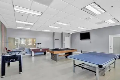 a room with two ping pong tables and a tv at Luxury Sky Villa with City and Ocean Views in Miami
