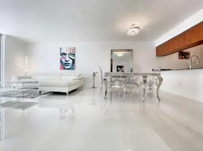a white living room with a table and chairs at Blissful Sky Residence with Ocean and City Views in Miami