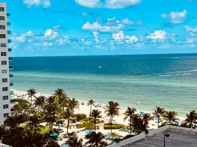 a view of the beach from the balcony of a resort at Oceanview Beachfront Condo on Tides Resort in Hollywood