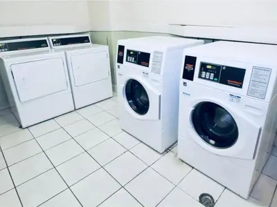 two washing machines and a washer and dryer in a kitchen at Oceanview Beachfront Condo on Tides Resort in Hollywood