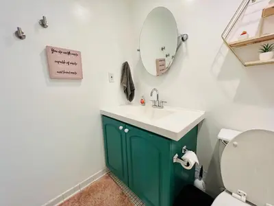 a bathroom with a green sink and a mirror at Oceanview Beachfront Condo on Tides Resort in Hollywood