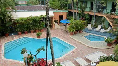 an aerial view of two swimming pools in a resort at Victoria Park Hotel in Fort Lauderdale