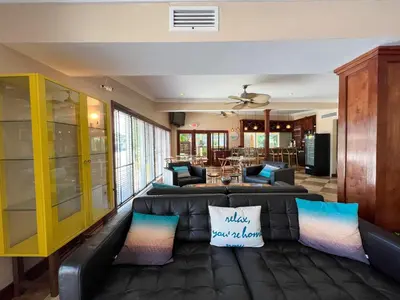 a living room with a leather couch and chairs at Victoria Park Hotel in Fort Lauderdale