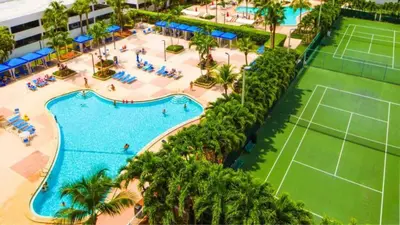 an overhead view of a pool with a tennis court at Family Beach Home w Ocean & Bay Views - Upgraded Corner Unit in Miami Beach