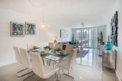 a dining room and living room with a table and chairs at ⌘Family Beach Home w Amazing Water Views - Upgraded Unit ⌘ in Miami Beach
