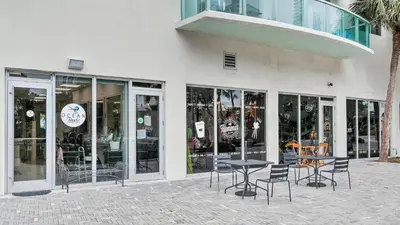 a store with chairs and tables in front of a building at ⌘Family Beach Home w Amazing Water Views - Upgraded Unit ⌘ in Miami Beach