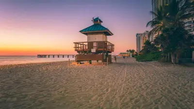a lifeguard tower on the beach at sunset at ⌘Family Beach Home w Amazing Water Views - Upgraded Unit ⌘ in Miami Beach