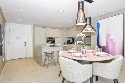 a kitchen and dining room with a table and chairs at Oceanview 2BR Suite At Hyde Beach House - 5☆ Amenities in Hollywood