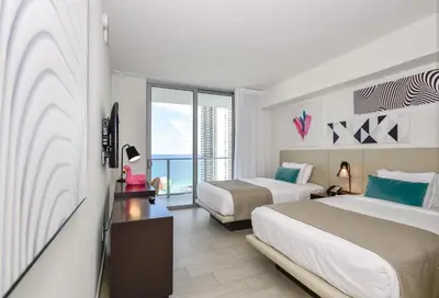 a hotel room with two beds and a balcony at Oceanview 2BR Suite At Hyde Beach House - 5☆ Amenities in Hollywood