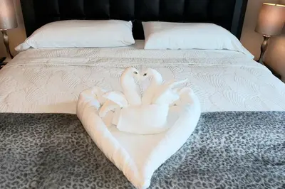 two swans made out of towels on a bed at Amazing Studio Located in Upscale-Prime Location. Walking Distance to Restaurant in Miami