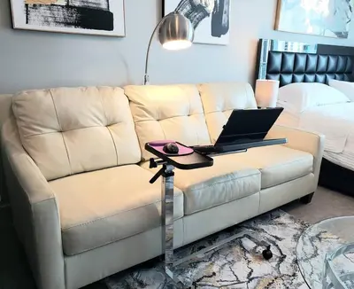a living room with a couch with a laptop on a table at Amazing Studio Located in Upscale-Prime Location. Walking Distance to Restaurant in Miami