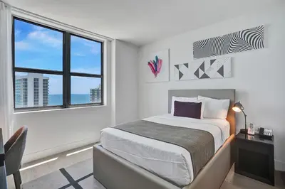 a white bedroom with a bed and a window at HYDE 2BR Panoramic Oceanview - No Resort Fees & Free Parking Exclusive to This Unit T3801 in Hollywood