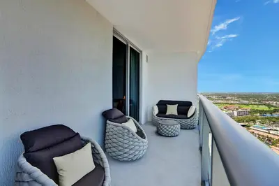 a balcony with couches and chairs on a building at HYDE 2BR Panoramic Oceanview - No Resort Fees & Free Parking Exclusive to This Unit T3801 in Hollywood