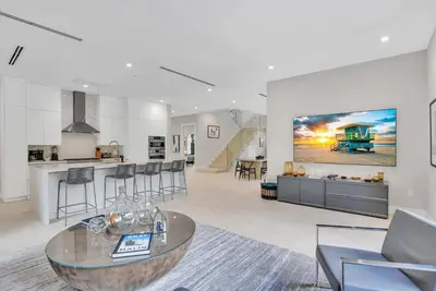 a living room with a table and a kitchen at Villa in Coral Gables with Pool Jacuzzi Game Room in Miami