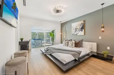 a bedroom with a large bed and a table and chairs at Miami Paradise - Htd Pool, Mini Golf, Playground, BBQ, Arcade Machine, baby items in Miami