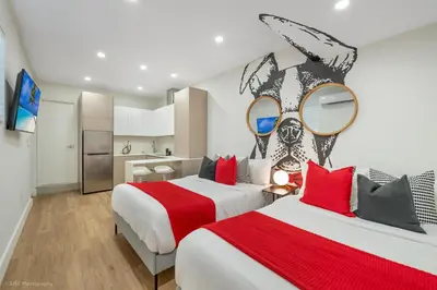 a bedroom with two beds with red pillows at Miami Paradise - Htd Pool, Mini Golf, Playground, BBQ, Arcade Machine, baby items in Miami