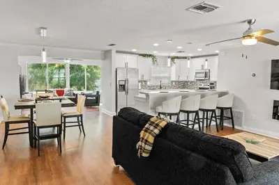 a living room and kitchen with a couch and a table at Stadium Sunflower Miramar home, 3 bd, 2 ba in Miramar