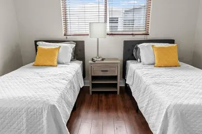 two beds sitting next to each other in a bedroom at Stadium Sunflower Miramar home, 3 bd, 2 ba in Miramar