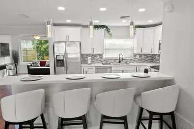 a kitchen with a large island with four chairs at Stadium Sunflower Miramar home, 3 bd, 2 ba in Miramar
