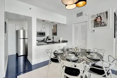 a kitchen and dining room with a table and chairs at 3BR Penthouse with European Flair n Amazing Views in Miami