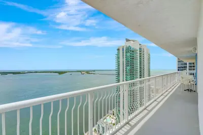 a balcony with a view of the ocean and a tall building at 3BR Penthouse with European Flair n Amazing Views in Miami