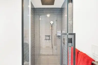 a shower with a glass door in a bathroom at Explore Miami's Heat - Cozy Studio POOL & GYM in Miami