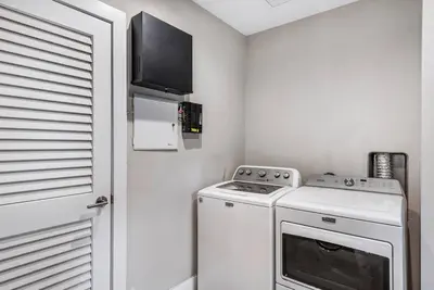 a small kitchen with a stove and a microwave at Coconut Grove Villa with heated Pool sleeps 12 in Miami
