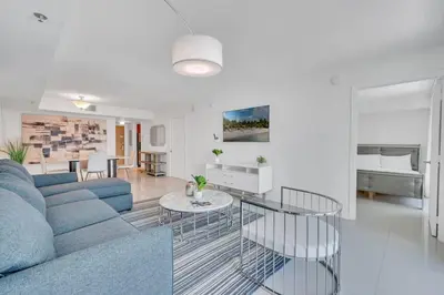 a living room with a blue couch and a table at Luxurious private unit with parking in Miami