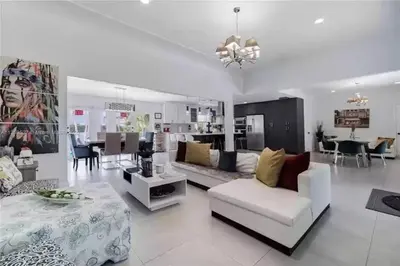 a living room with a couch and a table at Beachside Bliss Pool Retreat Half mile to Beach in Hollywood