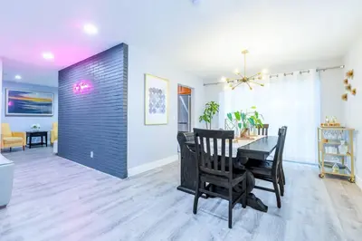 a dining room with a table and chairs in a room at Casa Tropicana - Heated Pool, Game Room & Mins from beach in Hallandale Beach