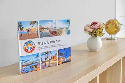 a book sitting on top of a table with a vase at Sistrunk Shades Villa #4 - Townhome Downtown Fort Lauderdale Near Cruise Port & FLL in Fort Lauderdale