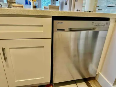 a dishwasher sitting under a counter in a kitchen at Stylish Stay Close to UM City Vibes in Miami