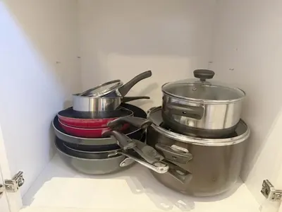 a group of pots and pans sitting on a stove at Stylish Stay Close to UM City Vibes in Miami