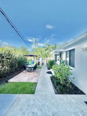 a house with a patio with a table and chairs at Stylish Stay Close to UM City Vibes in Miami