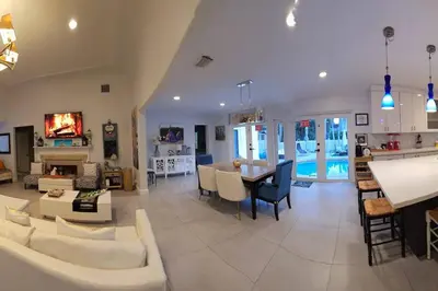 a living room with a couch and a table at Pool Paradise Half mile to Beach w Massive Yard! in Hollywood
