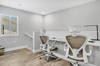 a white office with a desk and a chair at Sistrunk Shades Entire Compound 5 Homes 50 Guests in Fort Lauderdale