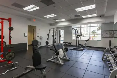 a gym with several treadmills and exercise machines at Glam Studio: Sleeps 4 x Pool x Gym x Parking in Miami