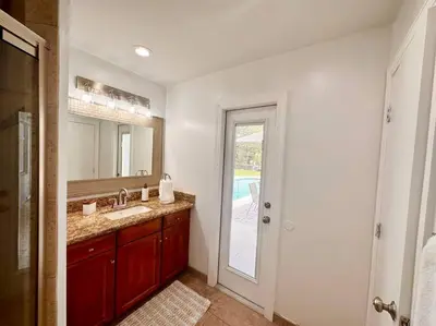 a bathroom with a sink and a mirror at Oasis in Plantation South Florida in Plantation