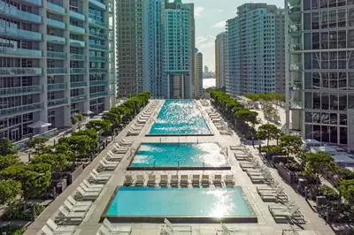 an aerial view of two pools in a city with tall buildings at LUX 2B-2B at ICON - Water View & 5-Star Amenities in Miami