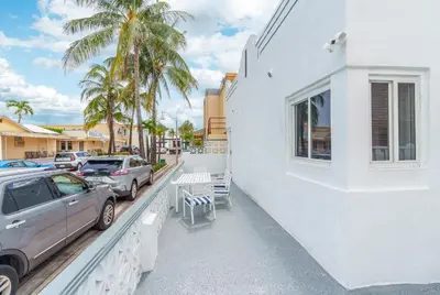 a car parked next to a white building with palm trees at 316 Seascape Unit 2 in Hollywood