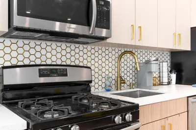 a kitchen with a stove and a microwave at 316 Footloose #3 in Hollywood
