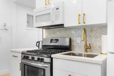 a kitchen with a stove and a microwave and a sink at 316 Footloose #1 in Hollywood