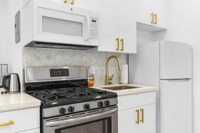 a kitchen with a stove and a microwave at 316 Footloose #1 in Hollywood
