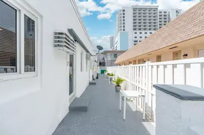a balcony of a white building with benches on it at 316 Footloose #1 in Hollywood