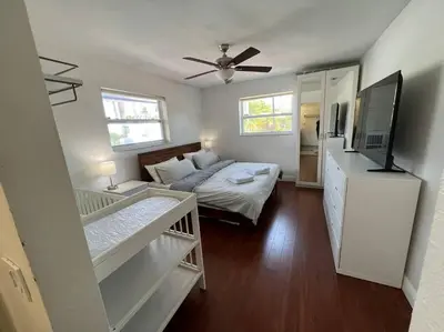 a bedroom with a bed and a flat screen tv at Designer Pool & Family Dream Home in Hollywood