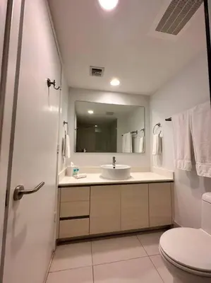 a bathroom with a sink and a toilet and a mirror at 3Bed/2Bath Hallandale Beach in Hallandale Beach