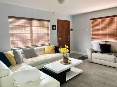 a living room with a white couch and a table at GREAT LOCATION Downtown/Airport/South Beach in Miami
