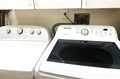 a white microwave next to a washing machine at SUPER CLOSE Beach, Airport, port, Downtown, Wynwood in Miami
